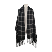 Black and white plaid shawl wrap with fringe on a mannequin against a white background