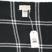 Black and white plaid fabric with a Mud Pie brand tag